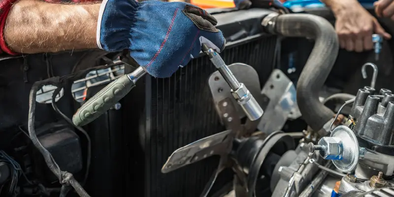 Image of a mechanic working on a radiator