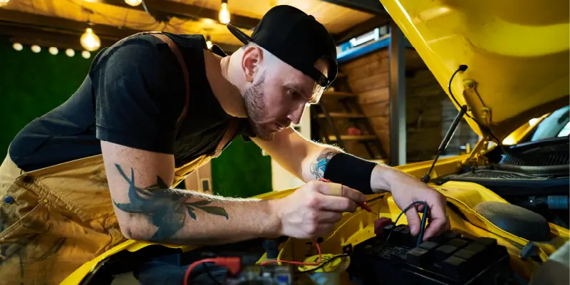 Image of a mechanic testing a battery