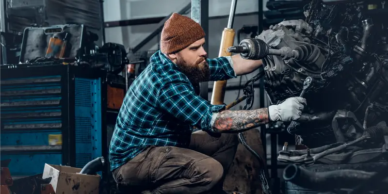 Image of 2 diesel mechanics repairing a truck